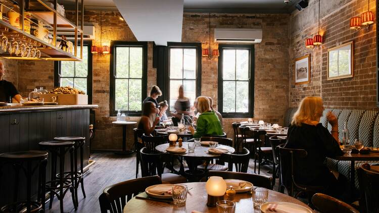 Inside the dining room at the Rover with a few tables sitting down enjoying their meals