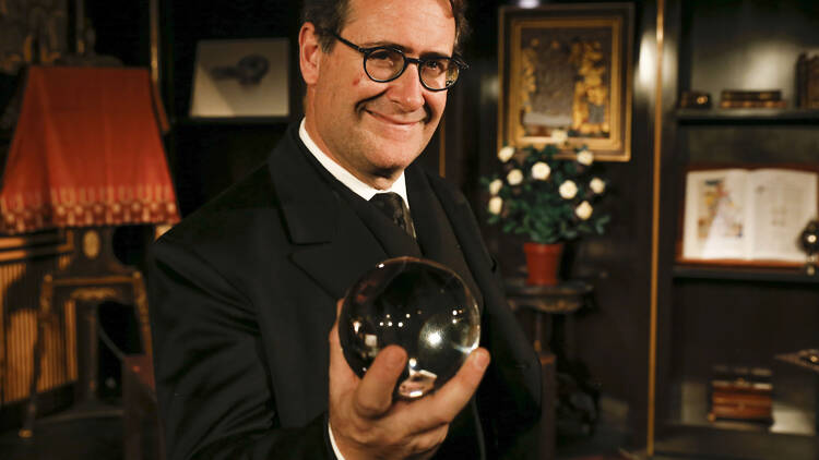 A magician holding a round object.