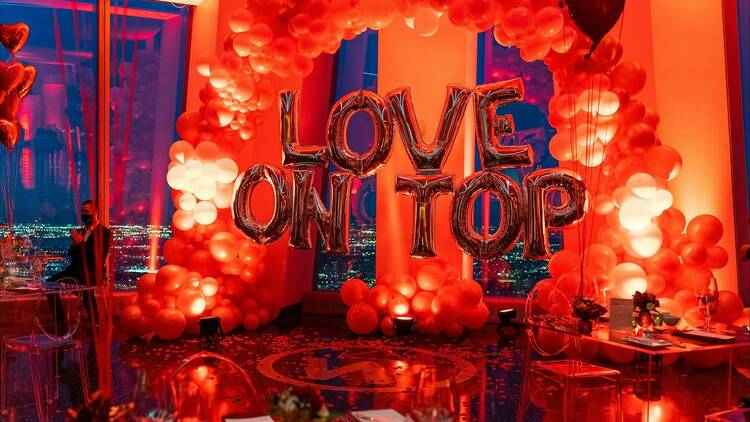 Balloons spell out Love On Top in One World Observatory.