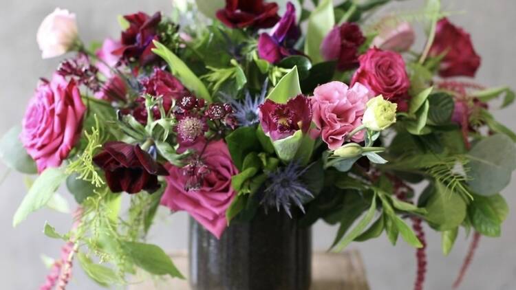 An arrangement of pink, red and purple flowers.