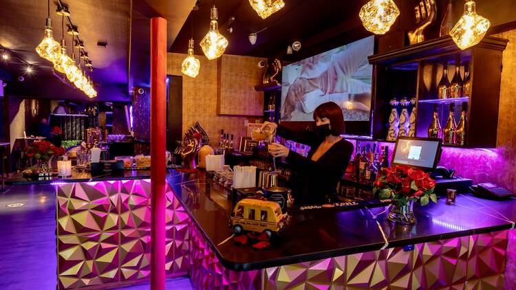 The bar at Lagos, where a bartender makes a drink.