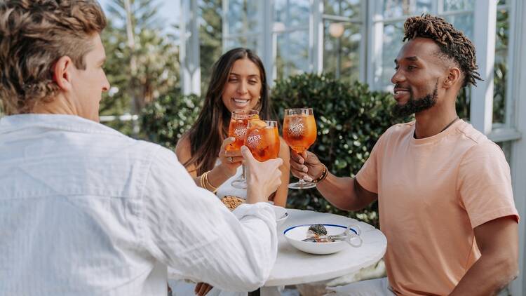 Three friends enjoying an Aperol Spritz