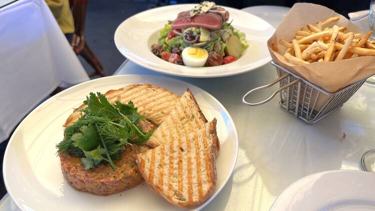 Monsieur Marcel steak tartare, shoestring fries and tuna Niçoise salad