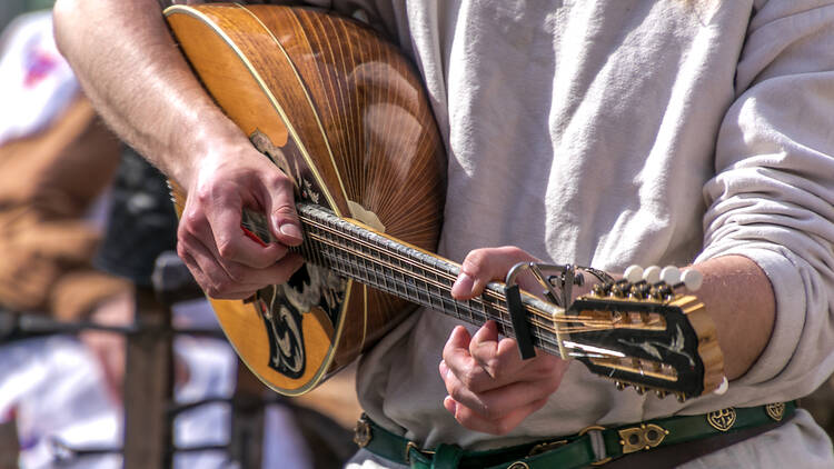 A person holding a stringed instrument.