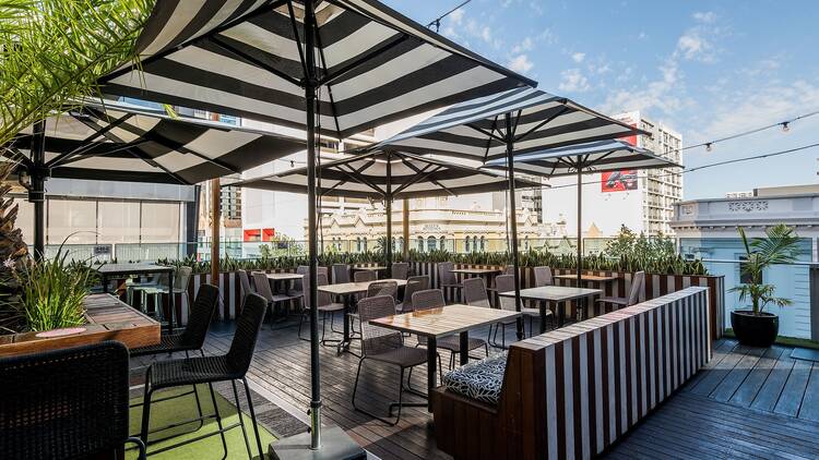 The Aviary with black and white umbrellas and a open air rooftop bar