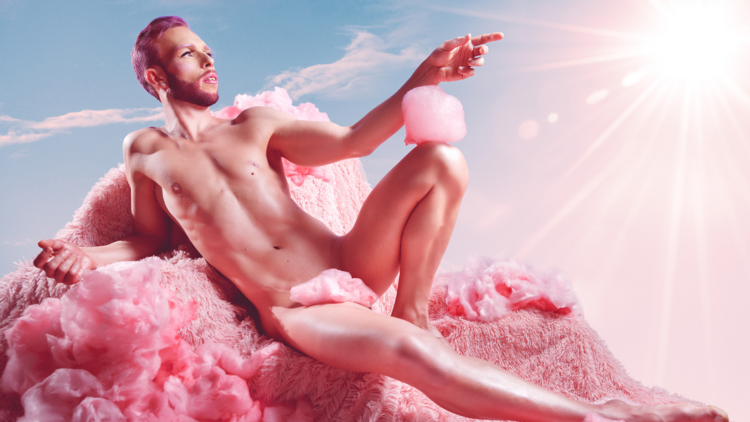 A man reclines naked on pink fluffy fabric 