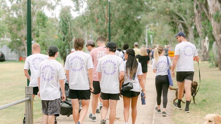 A group of people walking in Teresa's Trotters.