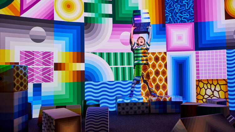 A child playing at the colourful exhibition PlayScapes