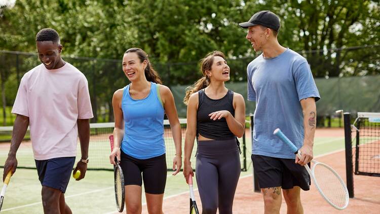 Four friends about to play tennis