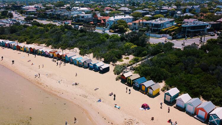An aerial shot of colourful beach boxes at a Melbourne beach.