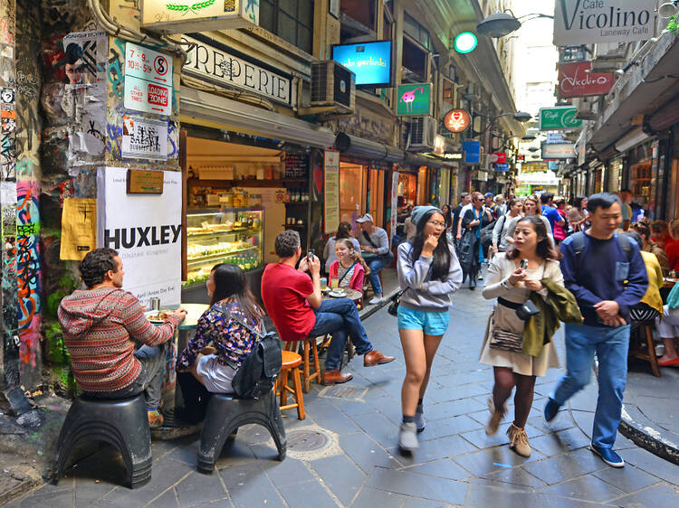 People walking through a crowded Melbourne laneway.