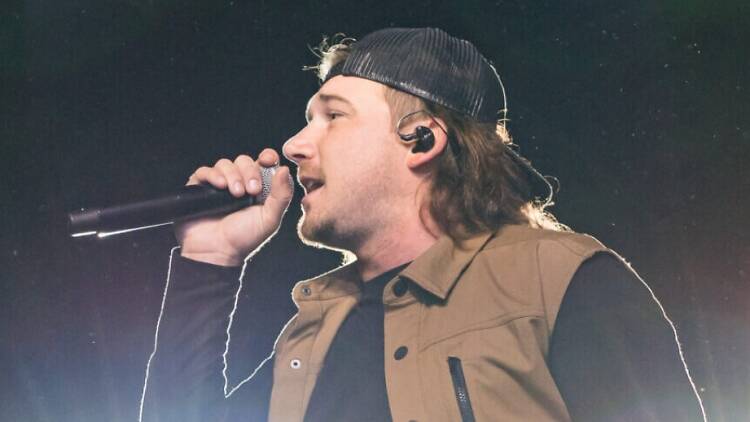 Country singer Morgan Wallen singing on stage.