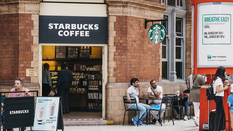 People drinking outside of Starbucks 