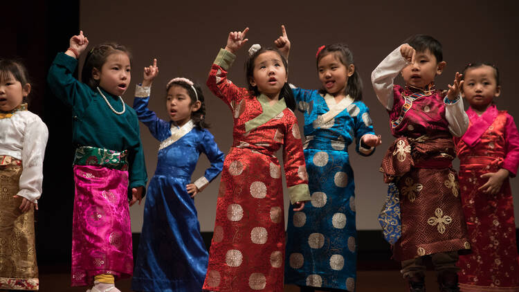 Children perform on stage. 