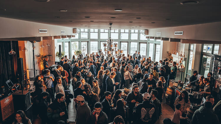 People sample whiskey at a festival.