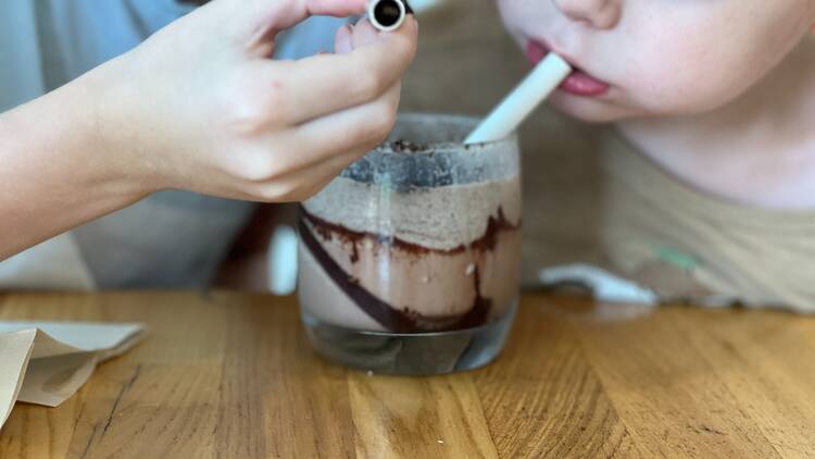 Two kids drinking a milkshake