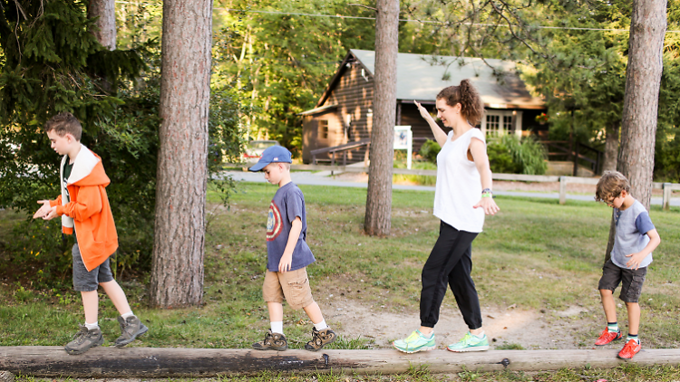 a family walking on a log together