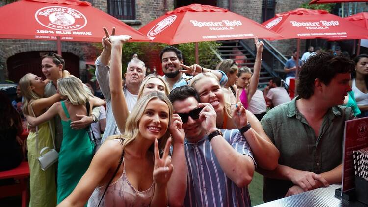 Friends enjoying the Rooster Rojo Tequila Takeover at the Argyle