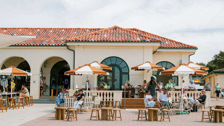 The outside of Glory Days with brown and white umbrellas