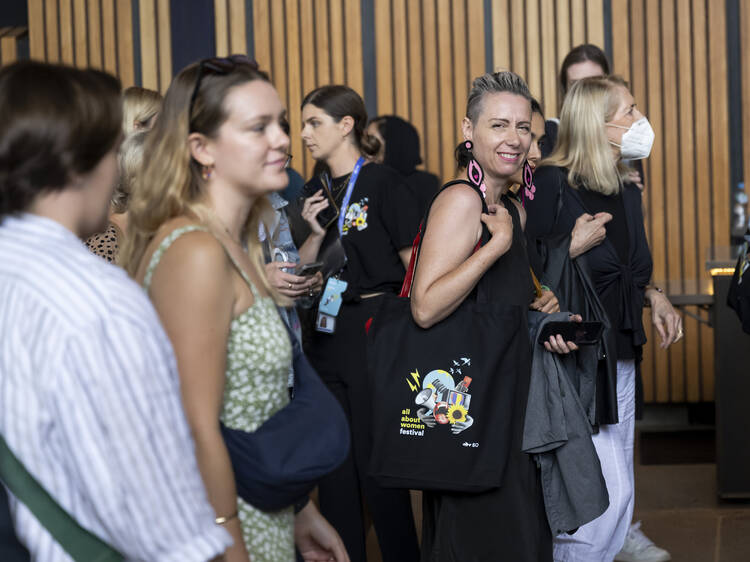 Women walking at an event.