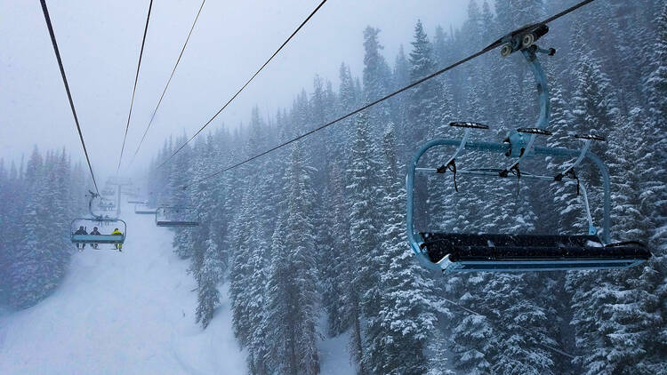 Shot of a ski lift on powder day in Vail, Colorado