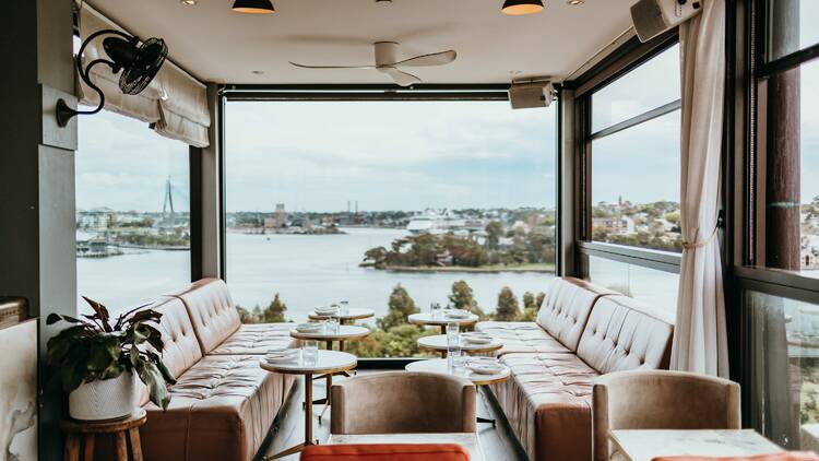 A bar with big windows and a great view of Sydney Harbour.