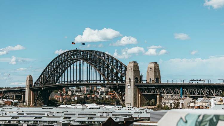 The Sydney Harbour Bridge against a blue sky.