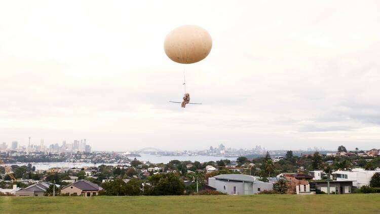A floating potato and the Smith's furry mascot hover over Sydney.