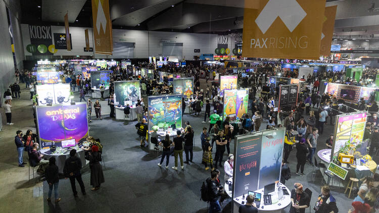 A large convention centre filled with gaming stalls.