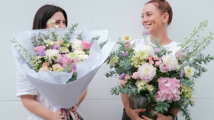 picture of women holding boquets of flowers