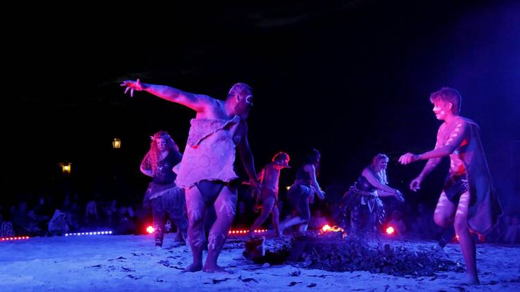 Men dancing around a fire at a Corroboree 