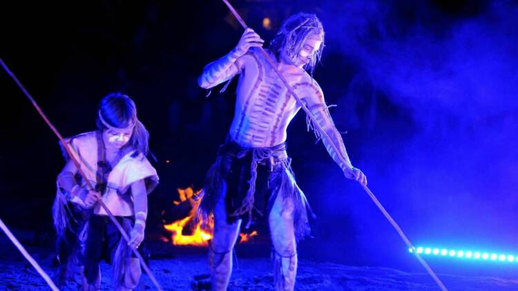 A man and a boy with sticks at a Corroboree