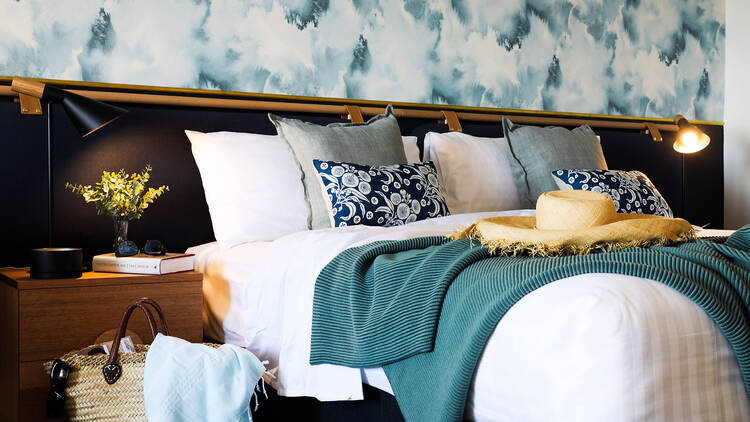 A hotel bed, with cushions piled up.