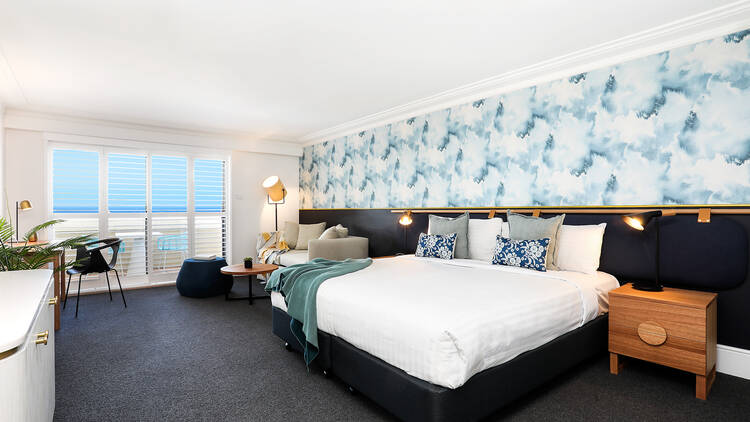 A hotel room with blue and white wallpaper.