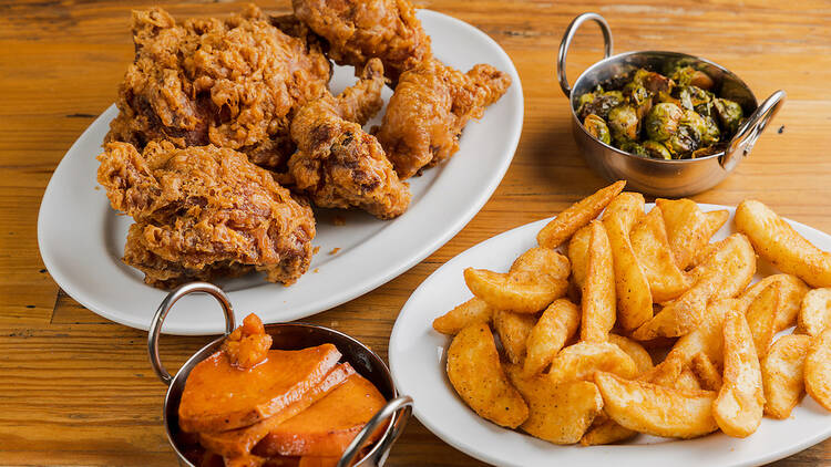 Willie Mae's Venice fried chicken, fries, brussels sprouts, and sweet potatoes