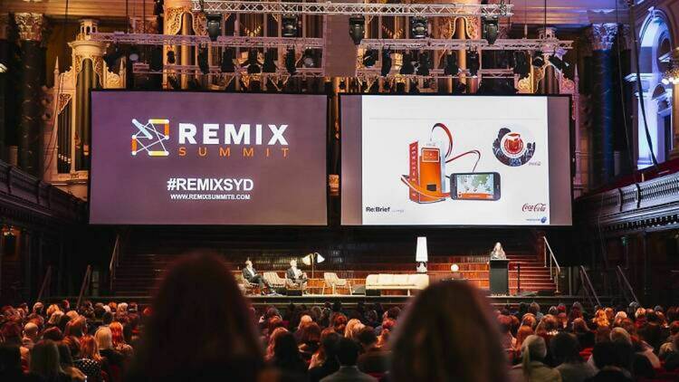 A hall with two big screens for Remix Summit
