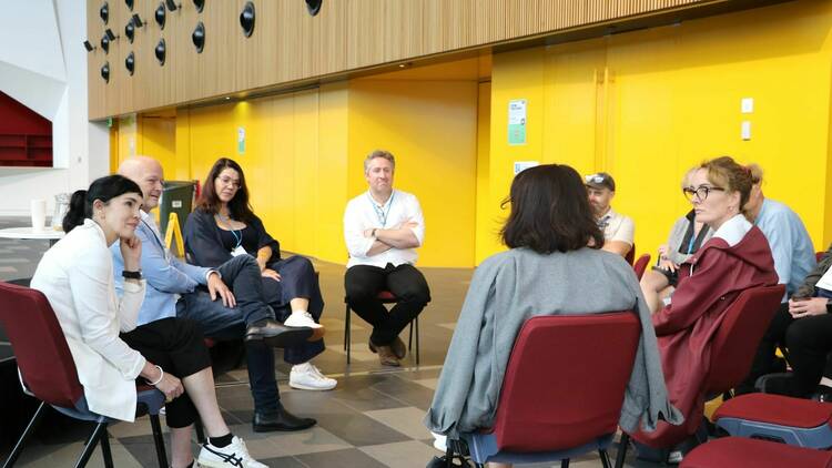 A group sitting in a circle networking