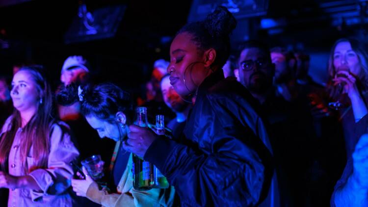 A crowd holds beers and dances at Live on the Lanes.