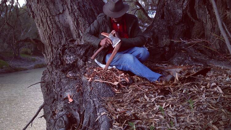 Uncle Badger Bates calving a boomerang on the Banks of the Barka