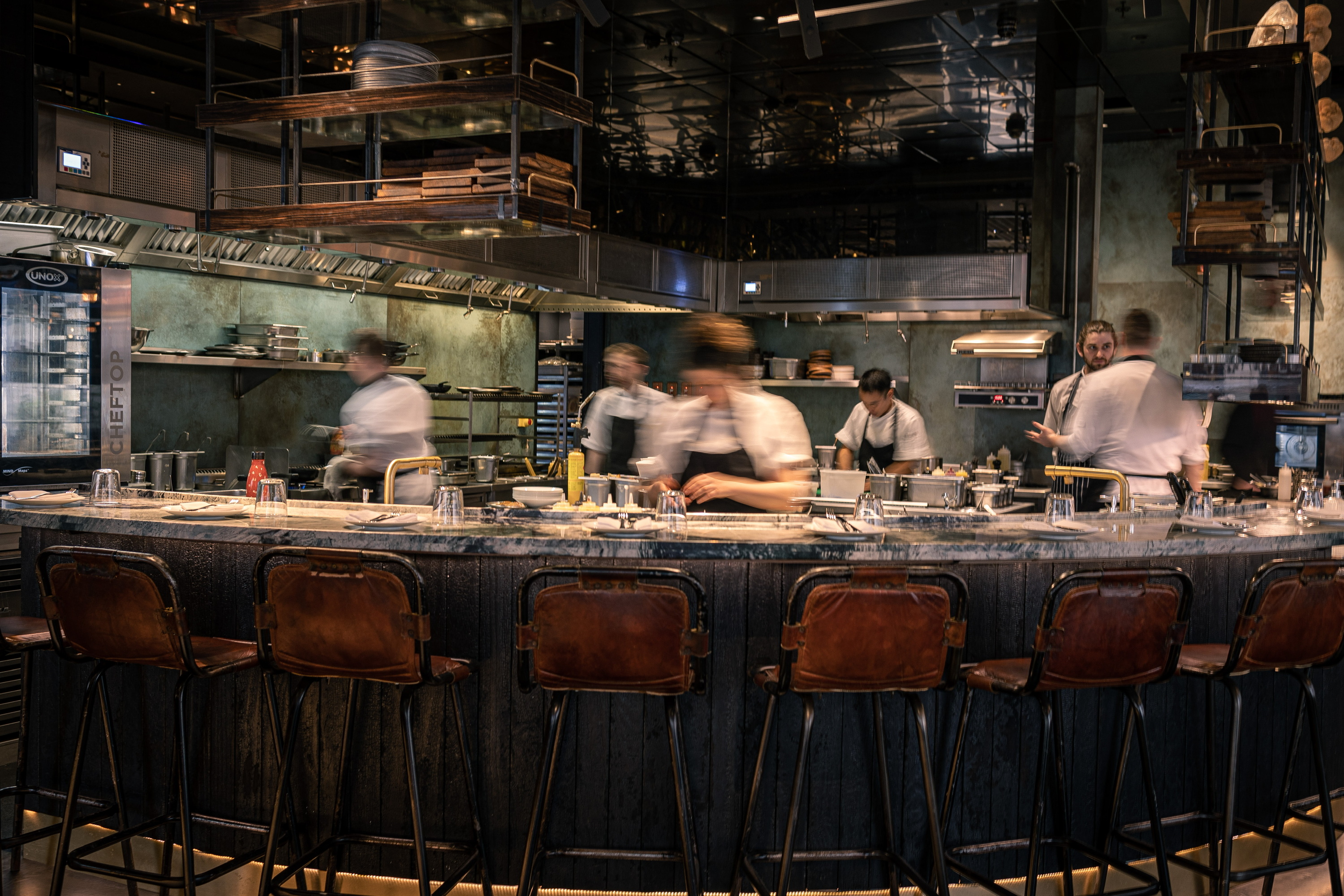 Staff behind kitchen counter at Fallow restaurant 