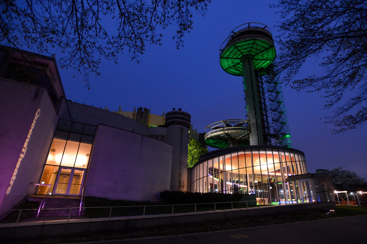 NYS Flushing Meadows Corona Park Pavilion lit up in green