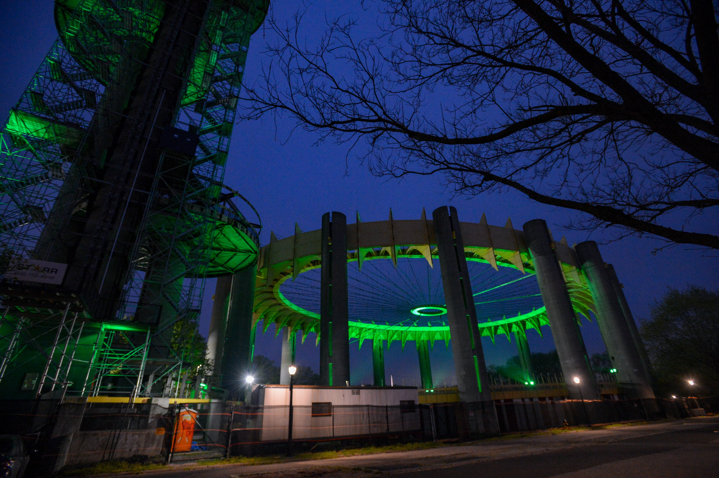 the NYS Pavilion in Flushing Meadows Corona Park lit in green