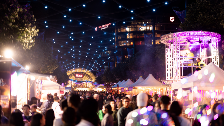 Night market with fairy lights and stalls