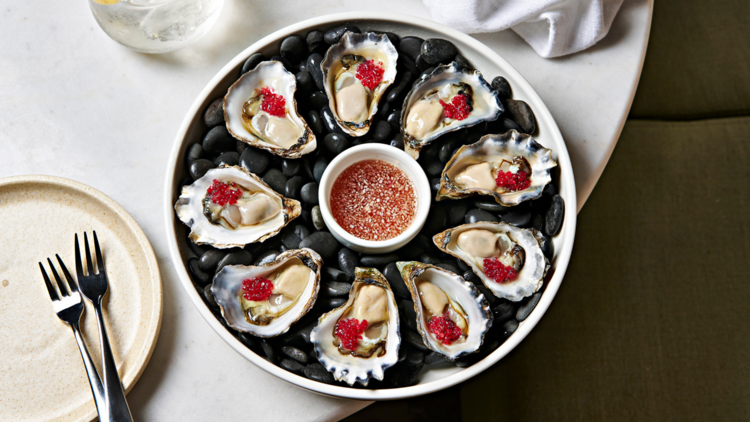 Oysters served on rocks with finger lime caviar 