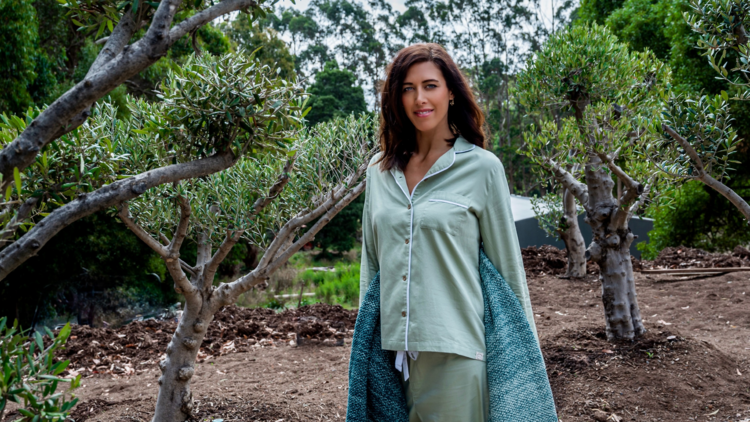 Woman standing in nature in satin pyjamas
