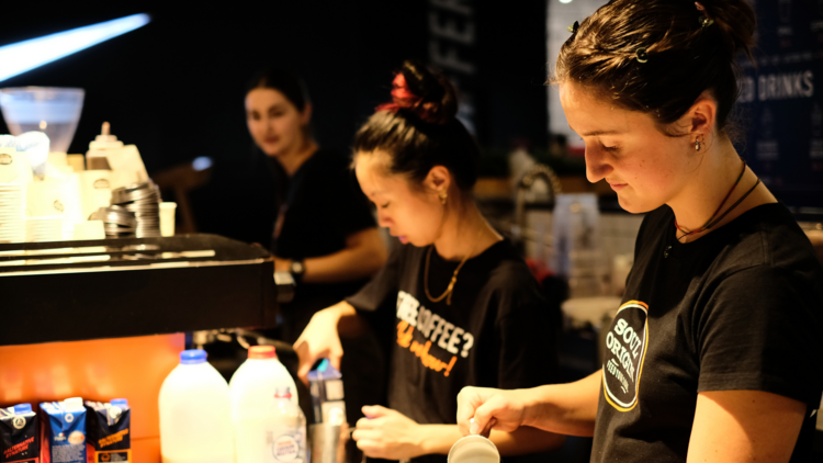 Two baristas making coffee