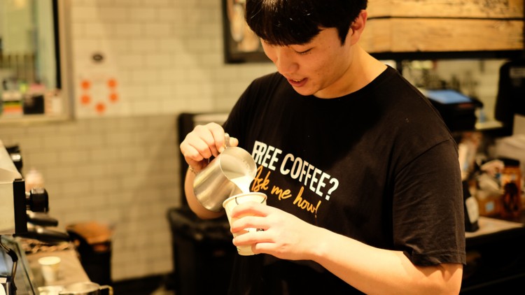 A barista making coffee