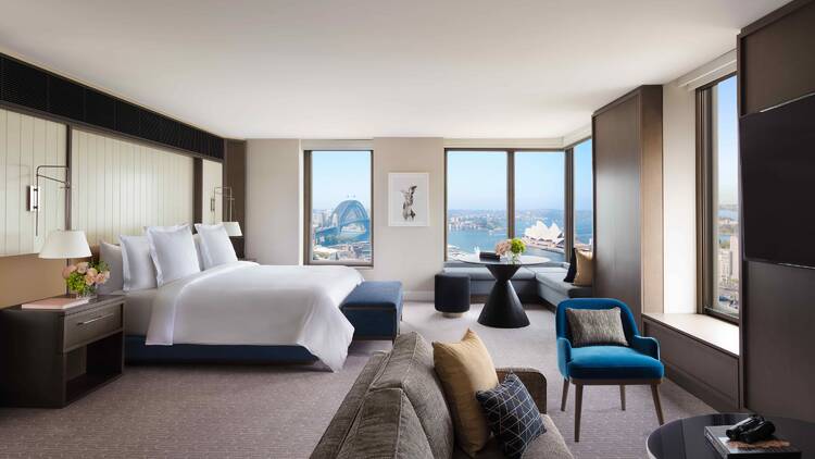 A hotel room with views of the Sydney Harbour Bridge and Opera House.