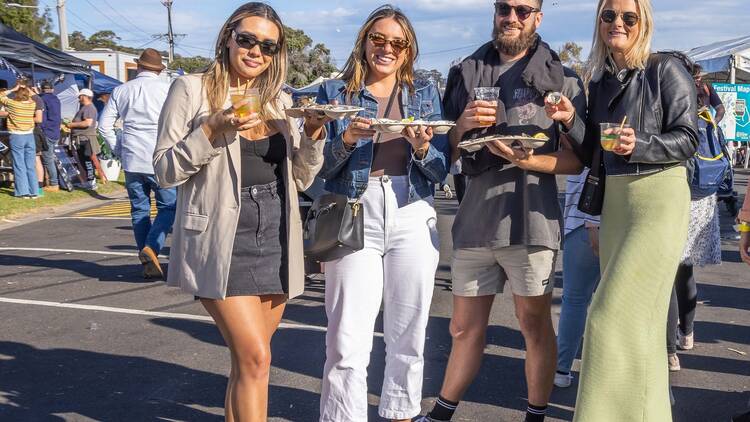 Friends enjoying oysters at Narooma Oyster Festival