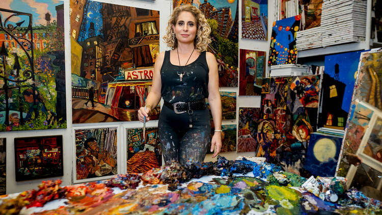 Sonya Sklaroff in her studio with artworks. 